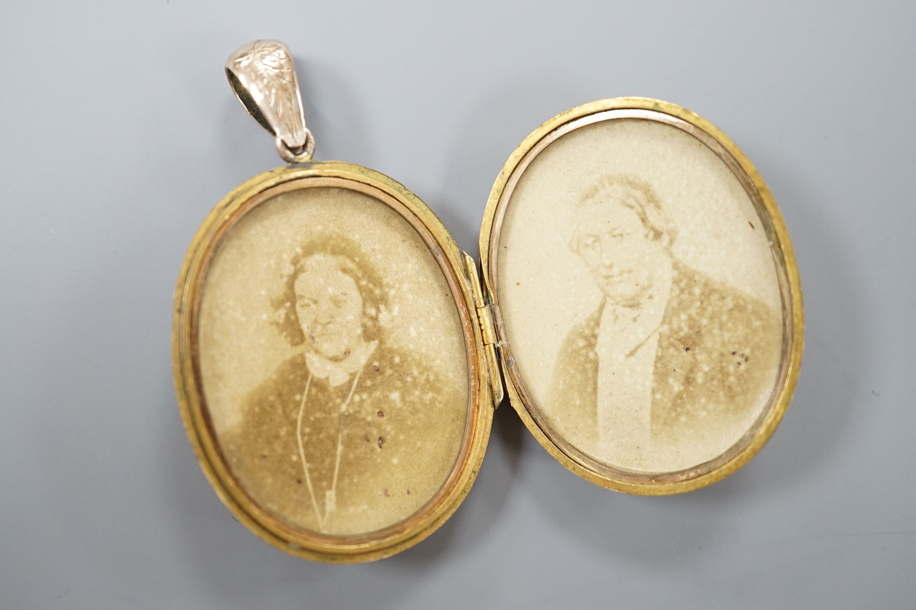 A Victorian engraved yellow metal oval locket, overall 55mm, gross weight 15.5 grams.